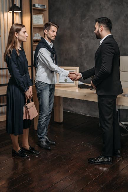 Business meeting in an office with a handshake sealing an agreement.